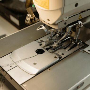 Detailed view of an industrial sewing machine, essential for garment production.